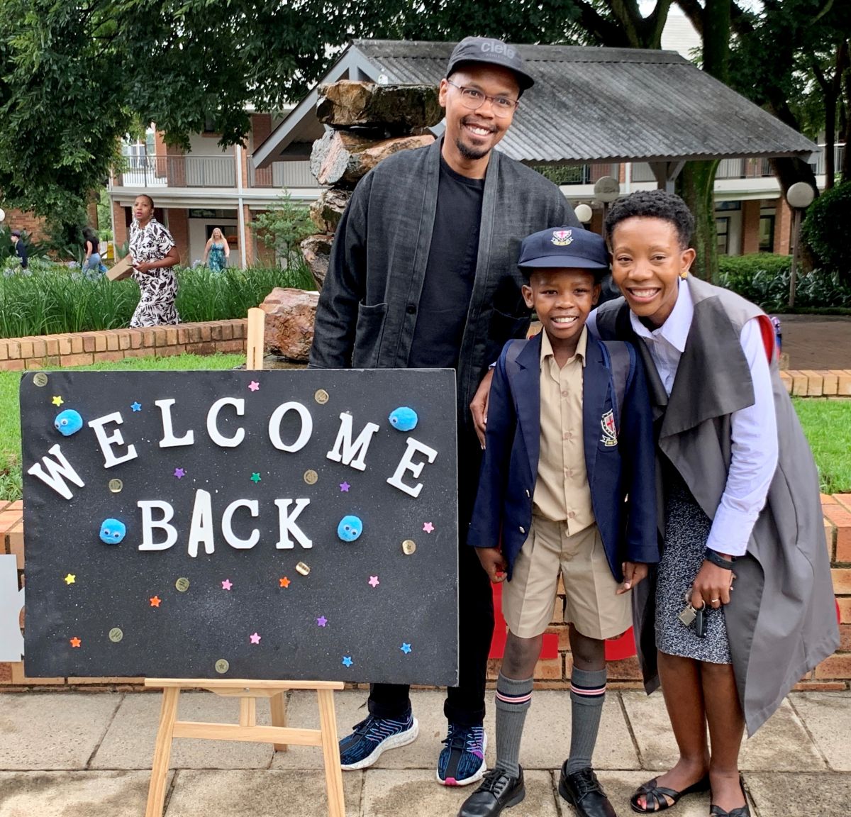 Family with welcome back sign